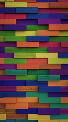 multicolored wooden wall made up of many different colored blocks and lines, with one section missing from the top