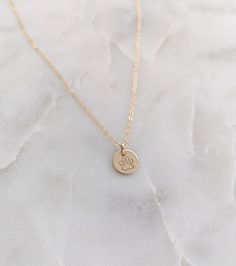 This memorial necklace for the loss of a dog features a 3/8" (9.5mm) disc personalized with a tiny pawprint design. It will be packaged on a necklace card that reads "our hearts are covered with the imprints of those who have loved us... and the best of those are pawprints"Includes a cable chain in your choice of length (16"-20"). All components of this necklace are .925 sterling silver or 14k gold fill depending on the selection made at checkout. What is "14k Gold Fill" ? Gold filled components Gold Paw Print Jewelry For Best Friend Gift, Gold Paw Print Jewelry For Best Friend, The Loss Of A Dog, Loss Of A Dog, Dog Memorial Gift, Memorial Necklace, Dog Memorial, Pet Loss, Gold Filled Jewelry