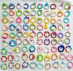 many different colored bracelets on a white surface