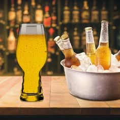 beer bottles and ice in a bucket on a table