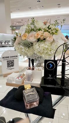 a display in a store filled with lots of white and pink flowers on top of a table