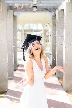 a woman in a graduation cap throwing confetti