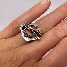 "A custom made designer mid century modernist ring in fine sterling silver.  This unique ring is in lovely condition and is absolute iconic of the era. Dating to the 1970s it could easily grace any coffee table book on fine jewelry design from the period.  In total it weighs 8.1 grams.  The face of the ring itself measures 11/16\" long by 15/16\" wide and rises 5/16\" high off the finger (18mm x 23mm x 8mm).  Currently this amazing hand made custom designed ring is a size 6 3/4. It can be resized to any size required at little cost.  This one of a kind modernist sterling silver ring will be sent in a presentation box." Luxury White Gold Modernist Rings, Contemporary Open Ring With Polished Finish, Modern Metal Signet Ring, Modern Hand Cast White Gold Ring, Unique Polished Finish Signet Ring, Unique Polished Signet Ring, Silver Brutalist Hand-cast Rings, Unique Hand Cast Signet Ring For Anniversary, Unique Polished Open Signet Ring