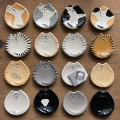 many different types of cat shaped plates on a table