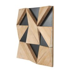 a wooden wall sculpture with black and grey panels on the front, made out of wood