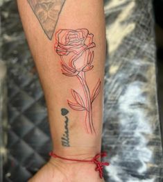 a woman's arm with a tattoo on it and a rose in the middle