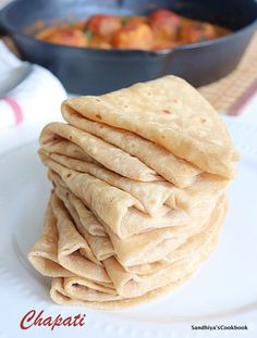 a stack of pita bread sitting on top of a white plate