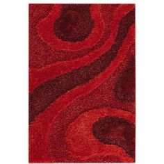 a red area rug with swirls on the top and bottom, in an abstract pattern