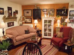 a living room filled with furniture and lots of pictures on the wall above it's fireplace