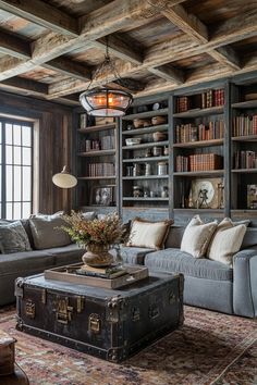 a living room filled with lots of furniture and bookshelves next to a window