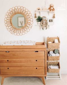 a baby's room with a dresser, mirror and teddy bear