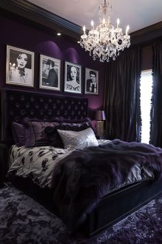 a purple bedroom with chandelier and pictures on the wall