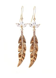 Clip-on style also available! These stunning gold crystal feather earrings make a beautiful statement! Cubic Zirconia flower crystal settings coupled with glass crystal studded gold feathers give these beauties a chic elegant look! 22k gold plated earring hooks add a rich feel, completing the pair! Shop now at KMagnifiqueDesigns.com Gold Feather Earrings For Party, Gold Feathered Jewelry For Parties, Elegant Dangle Earrings With Feathers, Elegant Dangle Feather Earrings, Elegant Feather Dangle Earrings, Gold Feather Jewelry For Wedding, Gold Feathered Wedding Jewelry, Elegant Feather Drop Earrings, Gold Feather Earrings As A Gift