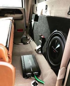 the inside of a vehicle with speakers and other items on the floor in front of it