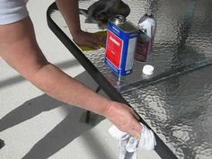 a person is cleaning the glass table top