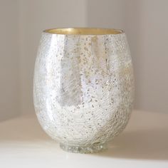 a close up of a glass vase on a white surface with light shining through it