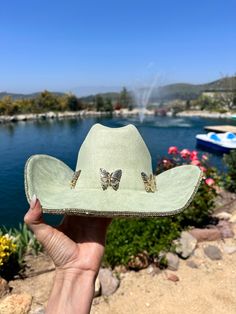 sage green/ light green hat with yellow gold rhinestones on the bottom brim.  Beautiful butterflies line the trim.  This is one size fits most, there's a drawstring to adjust sizing.  ships in 2 business days! Stunning in person  Perfect for Coachella , stagecoach, Nashville, country concerts, bachelorette parties, brides, weddings Please note that the hats are handmade and may have some variances and blemishes. If any, they are very minor . The hats might have a bit of "stickiness" from the glu Green Western Hats For Spring, Green Western Style Hats For Spring, Western Green Hat Bands For Festival, Western Green Hat Band For Festivals, Green Western Style Hat Band For Festivals, Gold Western Hat For Country Events, Green Wide Brim Western Hat, Western Green Hat For Country Events, Green Hat Bands For Rodeo With Short Brim