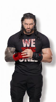 a man with long hair and tattoos holding a red glove