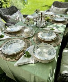 the table is set with plates and silverware