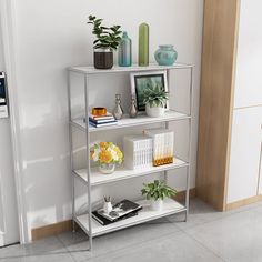 a metal shelf with books and vases on it