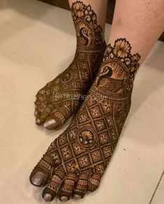 the feet and legs of a woman with henna tattoos