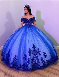 Step into your dream Quinceanera with the Fiora Ball Gown. This exquisite gown features a classic ball gown silhouette, beautifully crafted from layers of luxurious tulle fabric that add volume and movement to your every step. It is available in vibrant colors like royal blue, red, pink, purple, and green. The lace-up back ensures a perfect fit, accentuating your figure while adding a touch of classic charm. The intricate applique details and delicate beading sparkle with every turn, making you Aqua Blue Sweet 16 Dress, Azul Rey Quinceañera Dresses, Sweet 15 Dresses Quinceanera Blue, Xv Dresses Royal Blue, Royal Blue Sweet 16 Dresses Ball Gowns, Royal Blue 15 Dress, Dark Royal Blue Quinceanera Dresses, 15 Dresses Quinceanera Royal Blue, Xv Dresses Blue