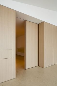 an empty room with sliding doors leading to another room