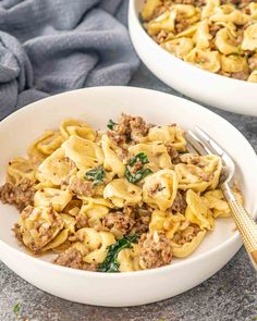 two white bowls filled with pasta and meat