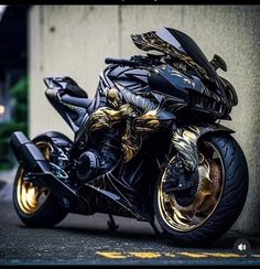 a black and gold motorcycle parked next to a building