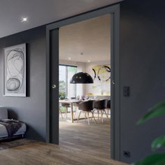 a living room filled with furniture and a painting on the wall above it's glass door