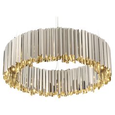 a modern chandelier made out of metal tubes and gold colored lights hanging from the ceiling