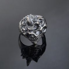 P R O D U C T ∙ D E S C R I P T I O N Unleash your bold style with this 925 Sterling Silver Ghost Rider Ring, designed for men who embrace the thrill of the ride. This Hand Made Horned Skull Ring features a meticulously crafted skull with horns, symbolizing strength and rebellion. Made from premium sterling silver, this piece combines durability with striking design. Ideal for bikers and rockers, this Silver Biker Ring adds a rugged edge to any look. The unique handcrafted detailing makes each r Silver Punk Rings With Skull Print, Silver Skull Ring For Biker Events And Halloween, Vintage Silver Skull Ring For Biker Events, Skull With Horns, Mens Skull Rings, Silver Mens Ring, Timeless Ring, Gothic Design, Biker Rings