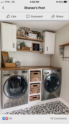 a small laundry room with two washer and dryers in it, next to some shelves