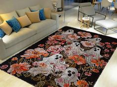 a living room with couches, chairs and rugs decorated with skulls and flowers