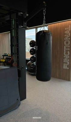 an empty gym with punching bags and equipment