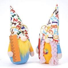 two colorful gnomes with numbers and letters on their heads, one holding a ruler