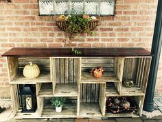 an old wooden cabinet with many compartments and shelves on the outside wall, in front of a brick building