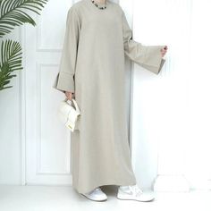 Casual Fall Abaya, Casual Winter Abaya, Beige Long Sleeve Modest Maxi Dress, Modest Beige Long Sleeve Maxi Dress, Casual Solid Color Abaya For Spring, Casual Long Abaya For Fall, Casual Abaya For Spring, Casual Solid Abaya For Spring, Casual Long Fall Abaya