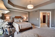 a bedroom with gray walls and carpeted flooring