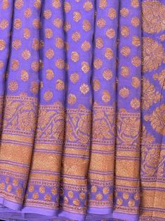 SILK MARK CERTIFIED !!!Stunning Lavender Color Pure Khaddi Georgette Silk Saree with Copper Zari and Wide Border. Floral Pattern Jaal on the border and Big Floral Butta on the Pallu giving it a grand look. Quite a Unique Color and Pattern Saree making it - A MUST HAVE in your Wardrobe !! Saree Fabric : Pure Khaddi Georgette Silk Color : Lavender Blouse piece : Comes with un-stitched Blouse piece.Fall & Edging(Yes/No) : YesSilk Mark Certificate given with the Saree(Yes/No) : Yes Disclaimer :-- Co Fitted Lavender Saree With Zari Work, Fitted Purple Traditional Wear With Zari Weaving, Lavender Traditional Wear With Cutdana, Festive Lavender Dupatta With Chikankari Embroidery, Festive Lavender Traditional Wear With Chikankari Embroidery, Lavender Fitted Saree, Fitted Lavender Saree, Traditional Lavender Dupatta With Zari Weaving, Semi-stitched Lavender Traditional Wear With Pallu