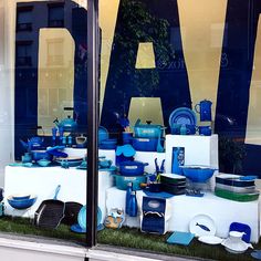 there is a display in the window of a store that sells blue and white dishes