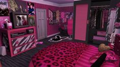 a bedroom decorated in pink, black and white with leopard print on the bedding