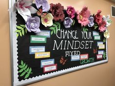 a bulletin board with flowers on it that says change your minds