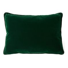 a green velvet pillow on a white background