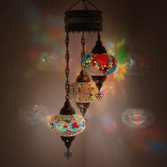 a chandelier hanging from the ceiling with many different colored glass balls on it