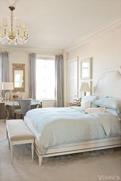 an instagram photo of a bedroom with chandelier and white bed linens