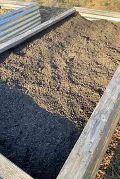 an empty garden bed with dirt in it