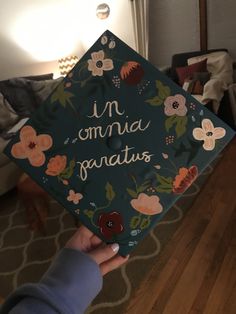 a person holding up a graduation cap that says i'm omma fanatis