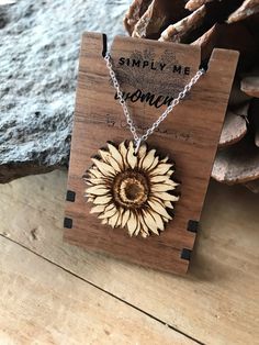 a wooden necklace with a sunflower on it