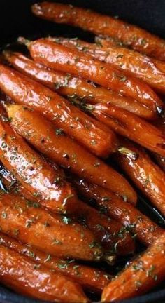 cooked carrots with herbs in a pan